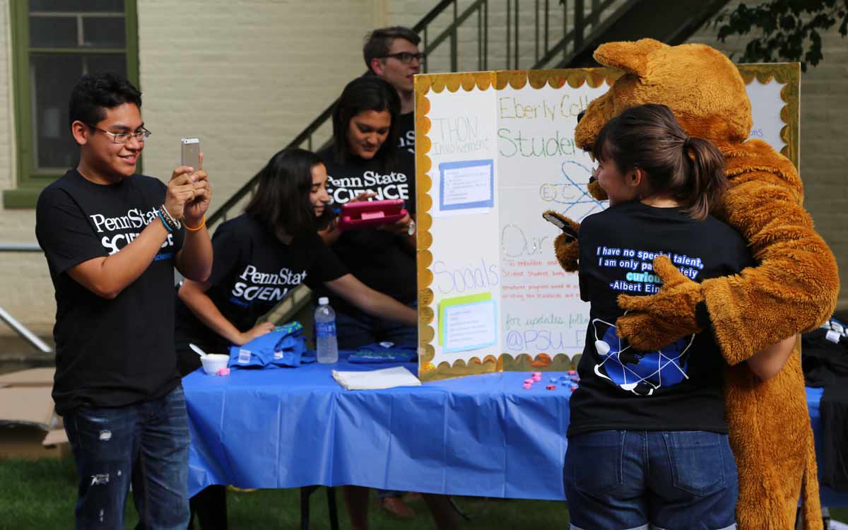 Students taking photos with the Nittany Lion