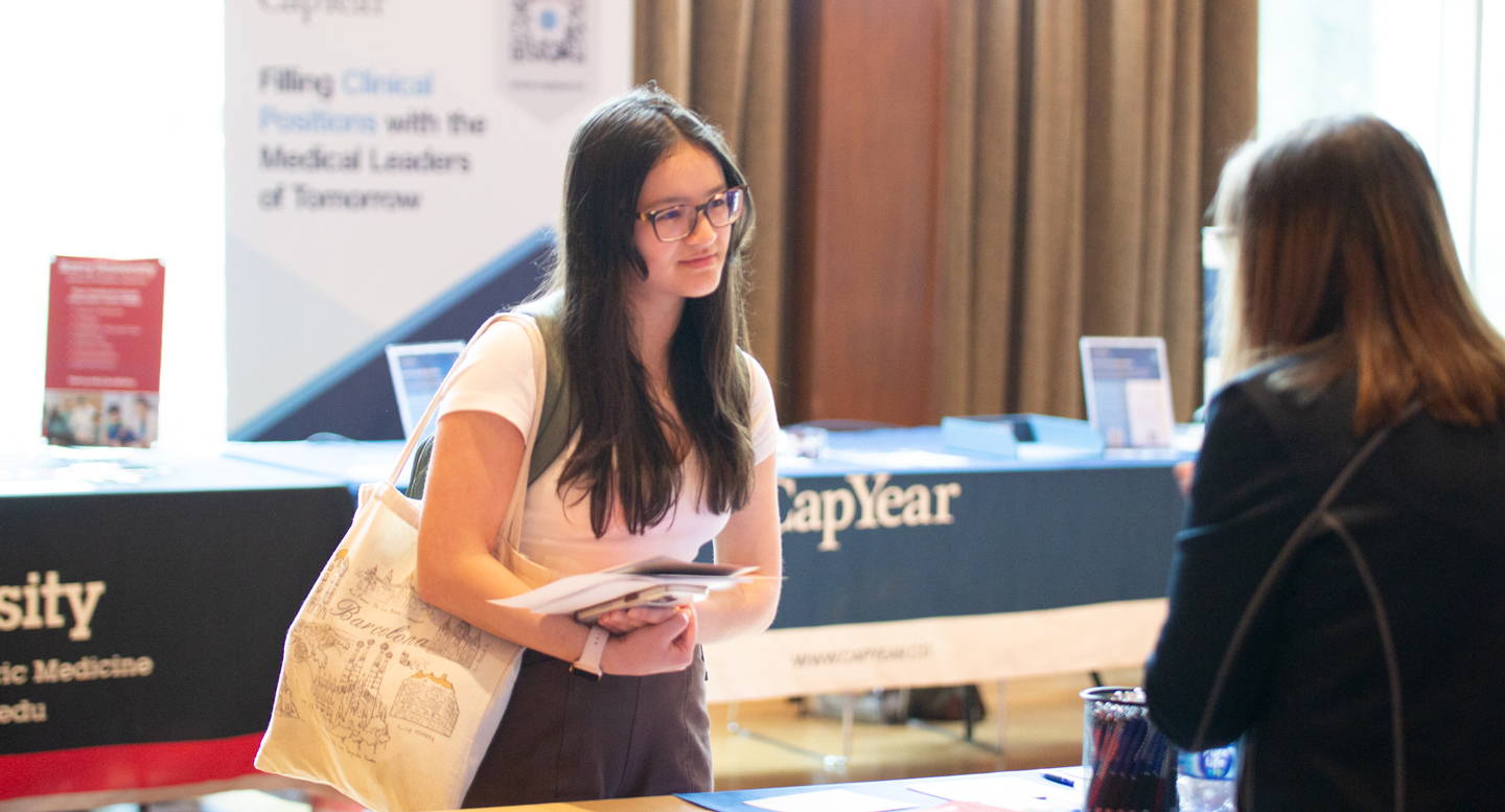 A student talks to a medical school representative a the Prehealth Expo.