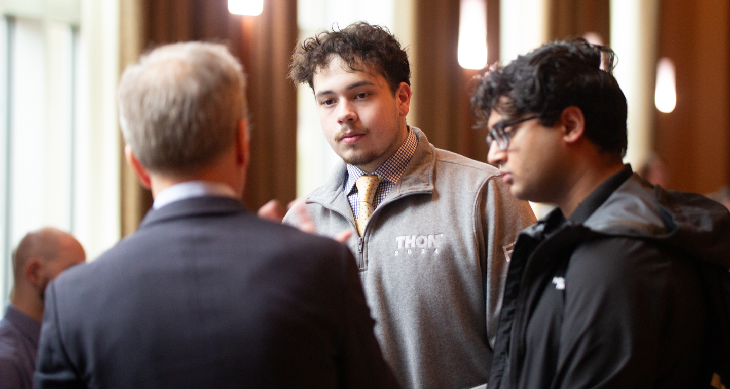 Undergraduate students talking with a medical school representative at the Health Professions Expo. 