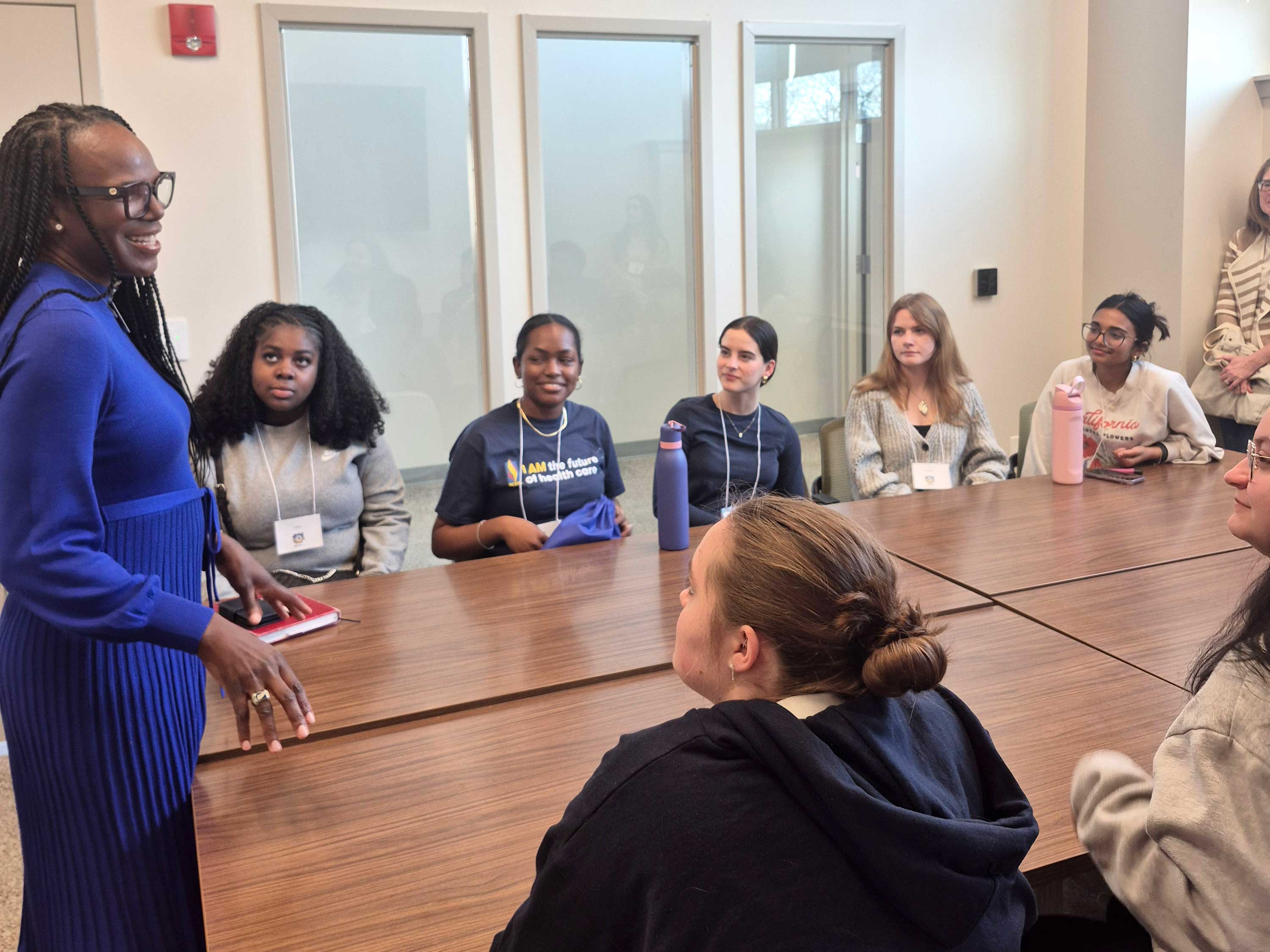 Ala Stanford speaks to group of sitting students