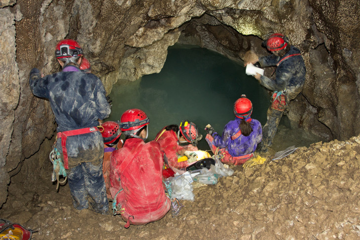 Penn State astrobiology students examine a sulfidic cave in Italy where white biofilm grows on the walls. Credit: Kyle Rybacki