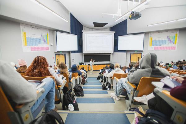 Matt Beckman speaks in a large lecture hall