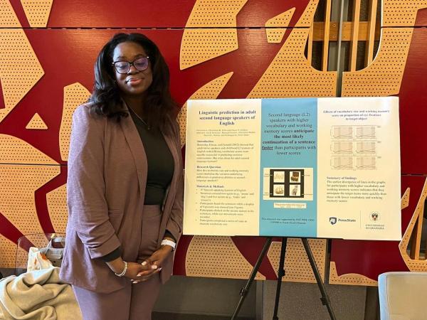 Ellis stands next to poster she presented