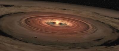 A newly formed star surrounded by a rotating disk of gas and dust, called a protoplanetary disk.
