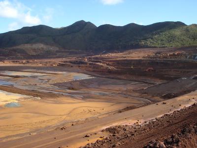 construction vehicles dig pit for mine tailings