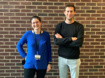 Lauren Zarzar and Caleb Meredith in front of brick wall