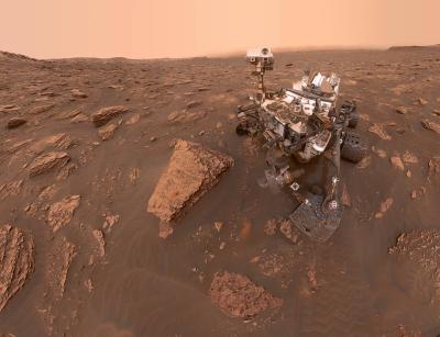 Curiosity rover on rocky surface of Mars