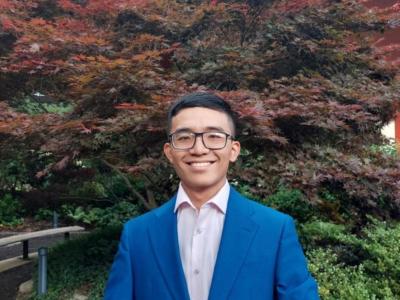 Loc Phan in suit outside