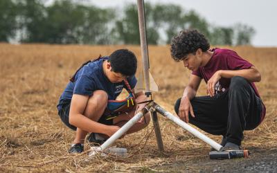 Two students during a rocket launch outreach event.