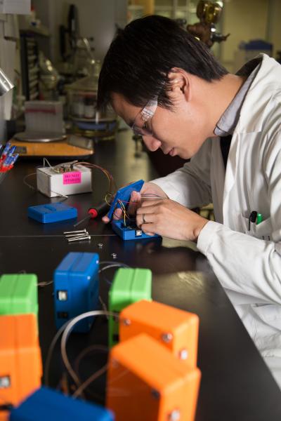 Chris Li assembling a potentiostat.