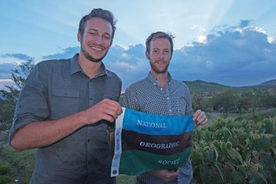 Zach Fuller and Jeff Kerby holding National Geographic flag
