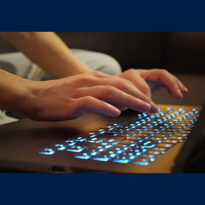 Person's hands typing on a computer