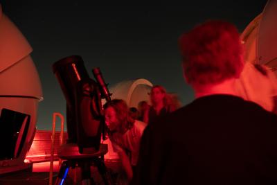 Members of the community use a telescope on the roof of Davey Lab during an AstroFest evening event.