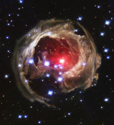 Space photo with a circle of brown surrounding a circle of red