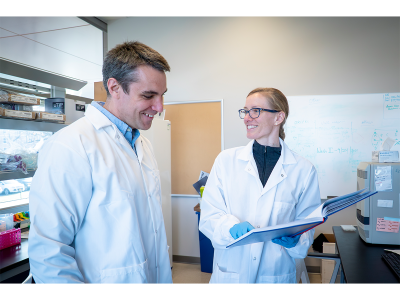 David Kennedy and Clara Shaw speaking in a lab.