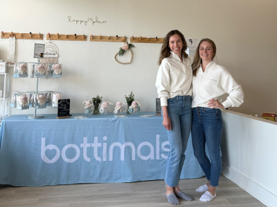 Julianne Gardner and Jill Cinalli standing in front of a table that says bottimals.