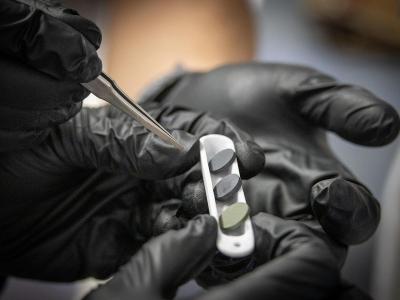 Three of the seven newly synthesized high-entropy oxide ceramic pellets are pictured.