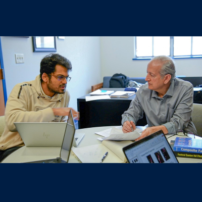 Jainandra Jain speaking to a grad student.