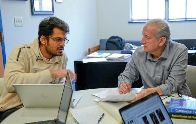 Jainendra Jain and his graduate student talking.