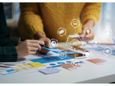 Two people working on a table with an overlay of different icons.