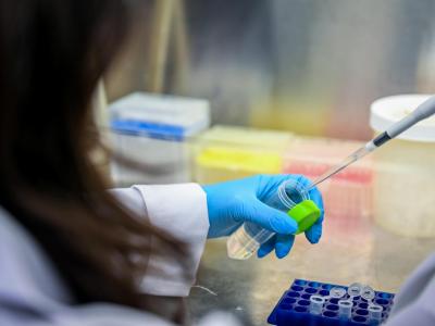 Student pipetting something into a test tube.