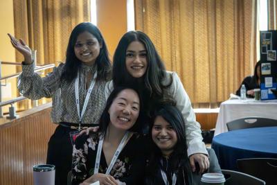 Group of attendees posing together near a table at the event.