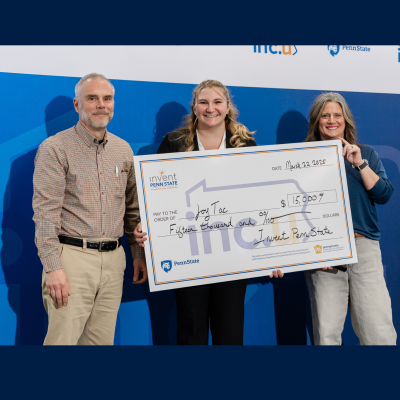 Two people presenting the student winner of the Invent Penn State Inc.U Competition with a giant check.