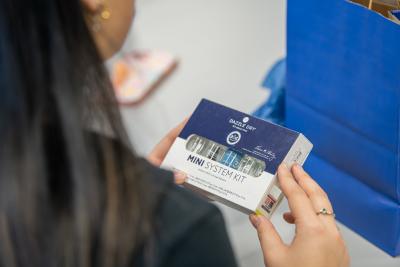 Girl holding the new Dazzle Dry x Penn State nail polish collab.
