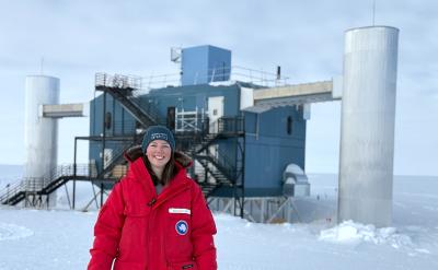 Kayla DeHolton in front of the IceCube Neutrino Observatory at the South Pole