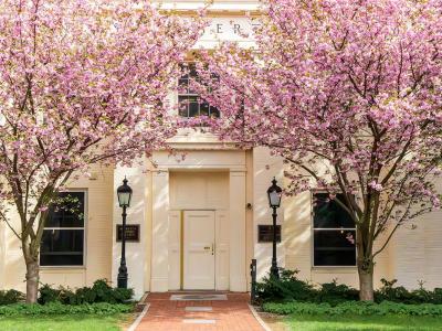 Atherton Hall on Penn State's campus with blooming trees around it.