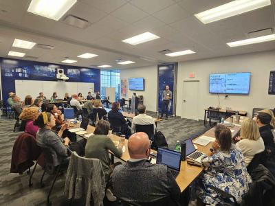 Group of people listening to Blake Colaianne, a researcher at Penn State's Prevention Research Center, as he hosted the first Summit on Flourishing in Adolescence at the Franco Harris Pittsburgh Center at Penn State on May 1. 2026. 