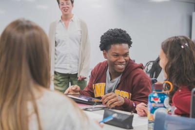 students smile as they discuss their project