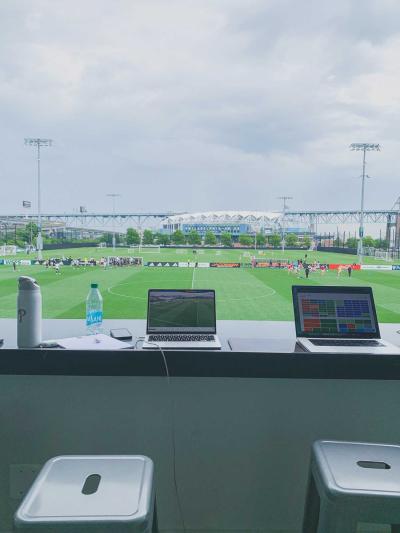 laptops on counter with soccer field behind