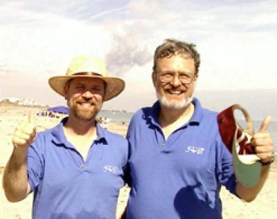 Penn State scientists, David Burrows (left) and John Nousek, reacting to the launch they have just viewed from the beach at their hotel in Cocoa Beach, The smoke trail from Swift's launch is still visible in the sky behind them.