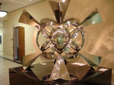 The sculpture measures about six feet in every direction and is mounted on a granite base about three feet high.