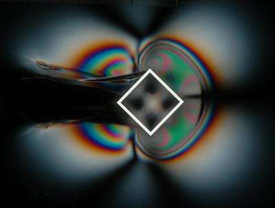 Credit: J. Gladden, A. Belmonte (Penn State)  Birefringent visualization of the micellar fluid layer around a diagonally oriented square "cutting tool." A white outline is superimposed on the outer edge of the square.