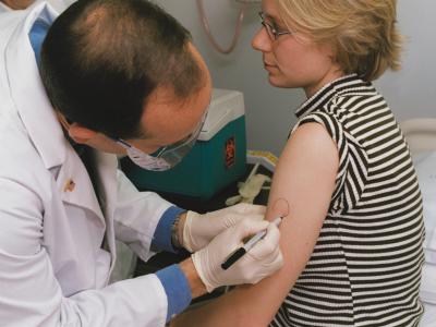 Doctor marking patient's arm in advance of administering a vaccine. Credit: NIH