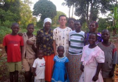 Residents of a Ugandan village are pictured with Schreyer Scholar Ce Zhang. Zhang visited Uganda as part of a research program that installed low-cost hand-washing taps in schools to reduce the spread of disease.