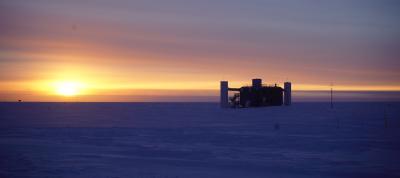 Sun setting behind the IceCube Lab at the South Pole. The Antarctic detector that identified the first likely source of high-energy neutrinos and cosmic rays, is getting an upgrade that will extend its scientific capabilities to lower energies. Credit: Kathrin Mallot, IceCube/NSF