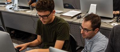 Students annotate genes collected by earlier CURE cohorts. Here Greg Broussard (right) works with a first-year student to properly annotate a phage sequence.