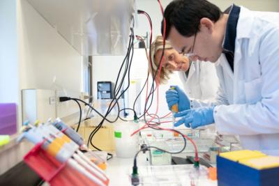 Mackenzie and colleague at lab bench