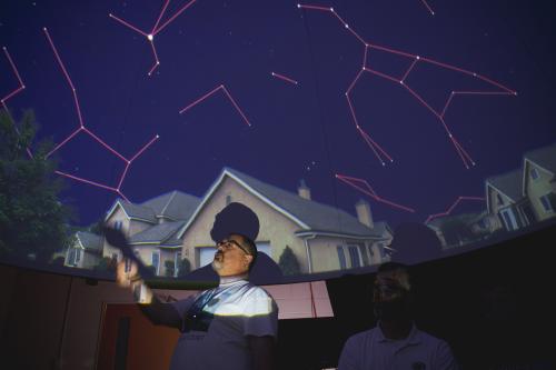 Chris Palma presenting to an audience at the planetarium during the 2025 AstroFest.