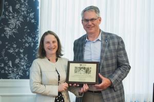 Christopher Cabell accepting the Outstanding Science Alumni Award from Dean Tracy Langkilde.