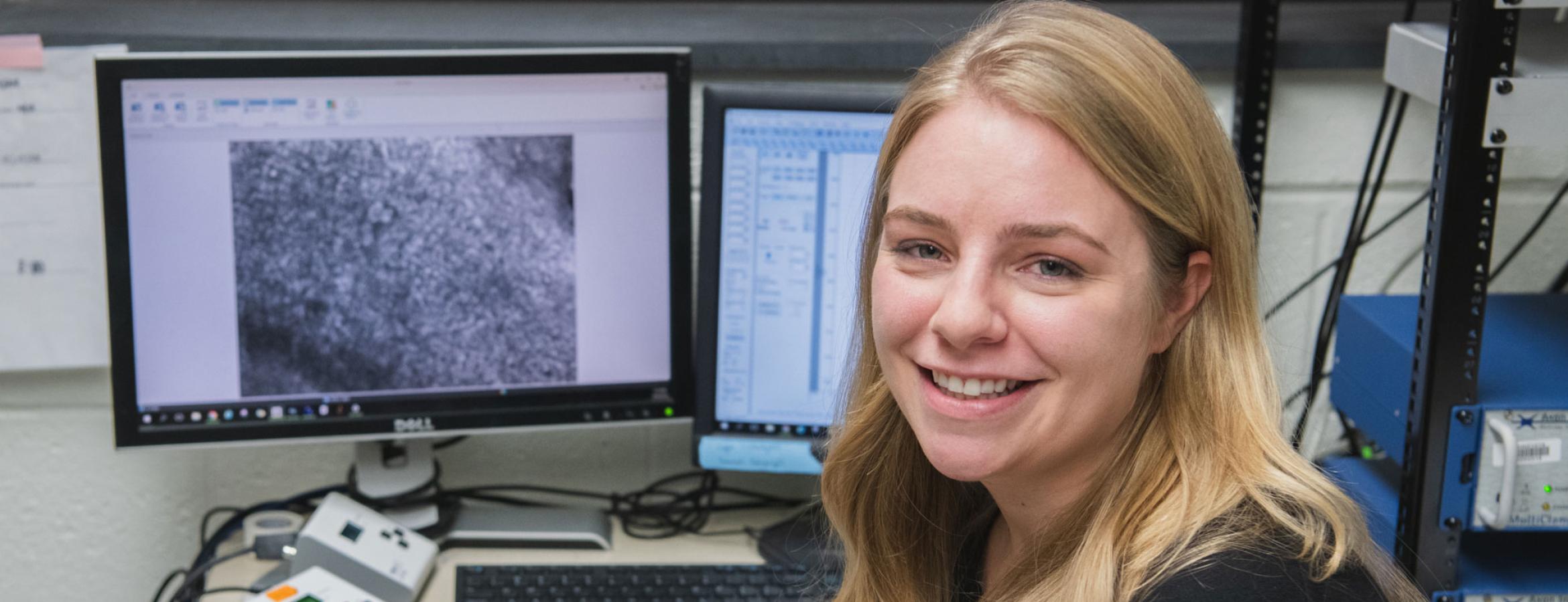 Laurel Seemiller sits in front of a computer
