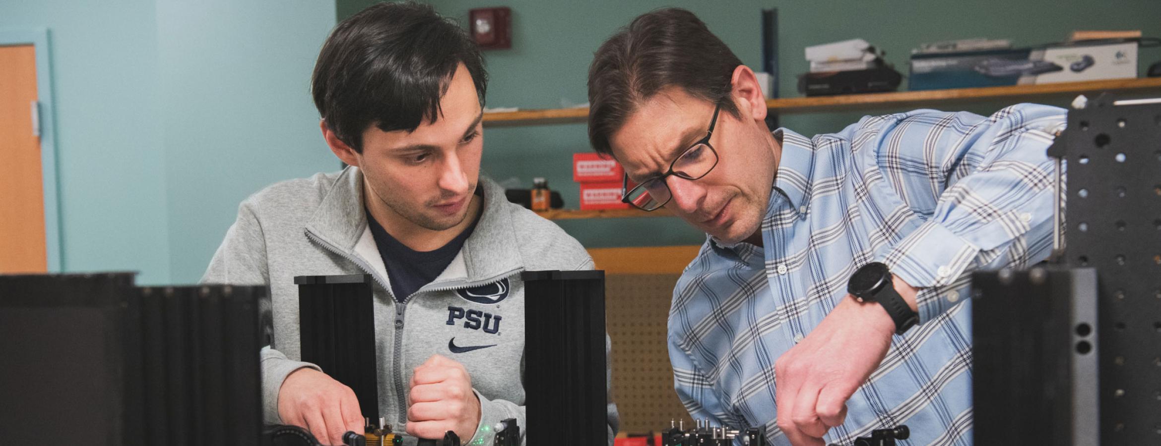 Ken Knappenberger and grad student Daniel Heintzelman work on equipment