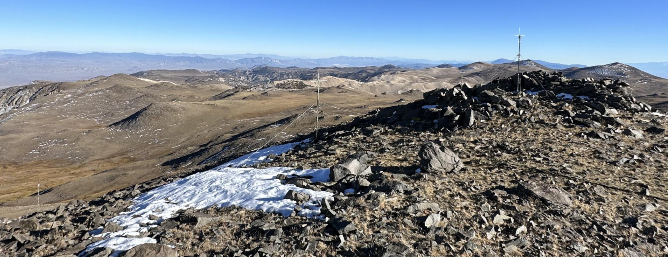 Mountain region with rocks and snow with radio antennae array