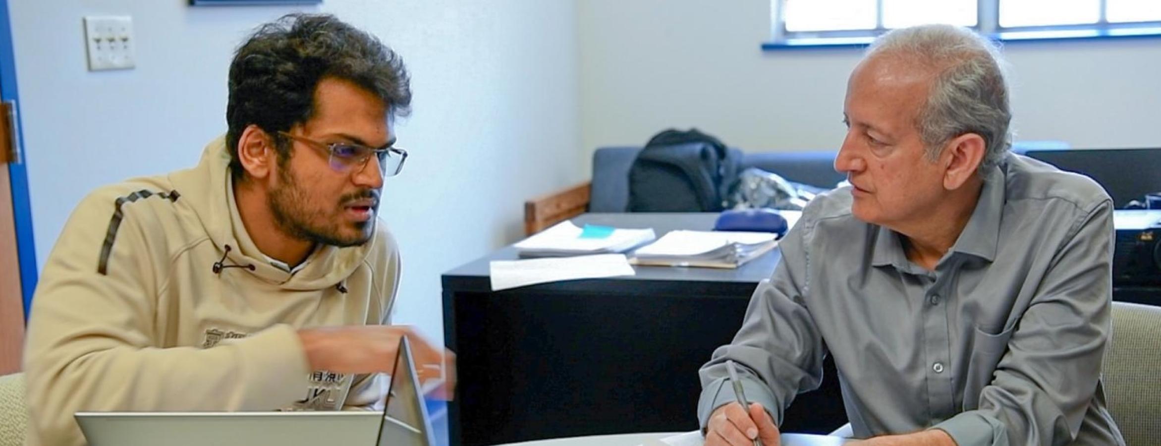 Jainendra Jain and his graduate student talking.