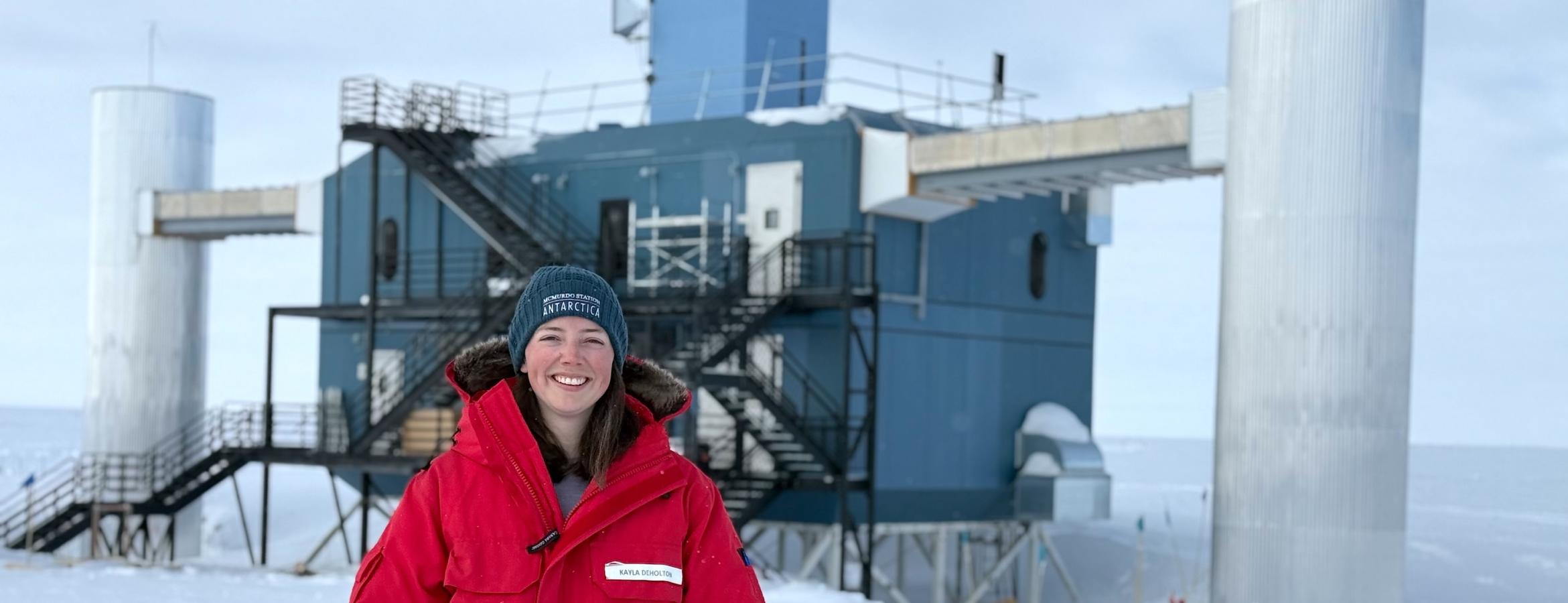 Kayla DeHolton in front of the IceCube Neutrino Observatory at the South Pole