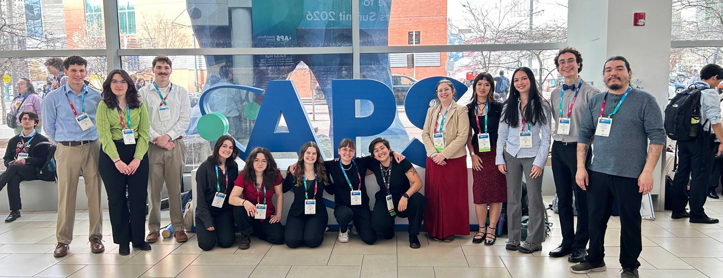 physics REU students gather in front of the APS sign at annual conference