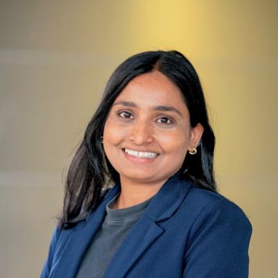 A picture of a Grad student in a blue blazer